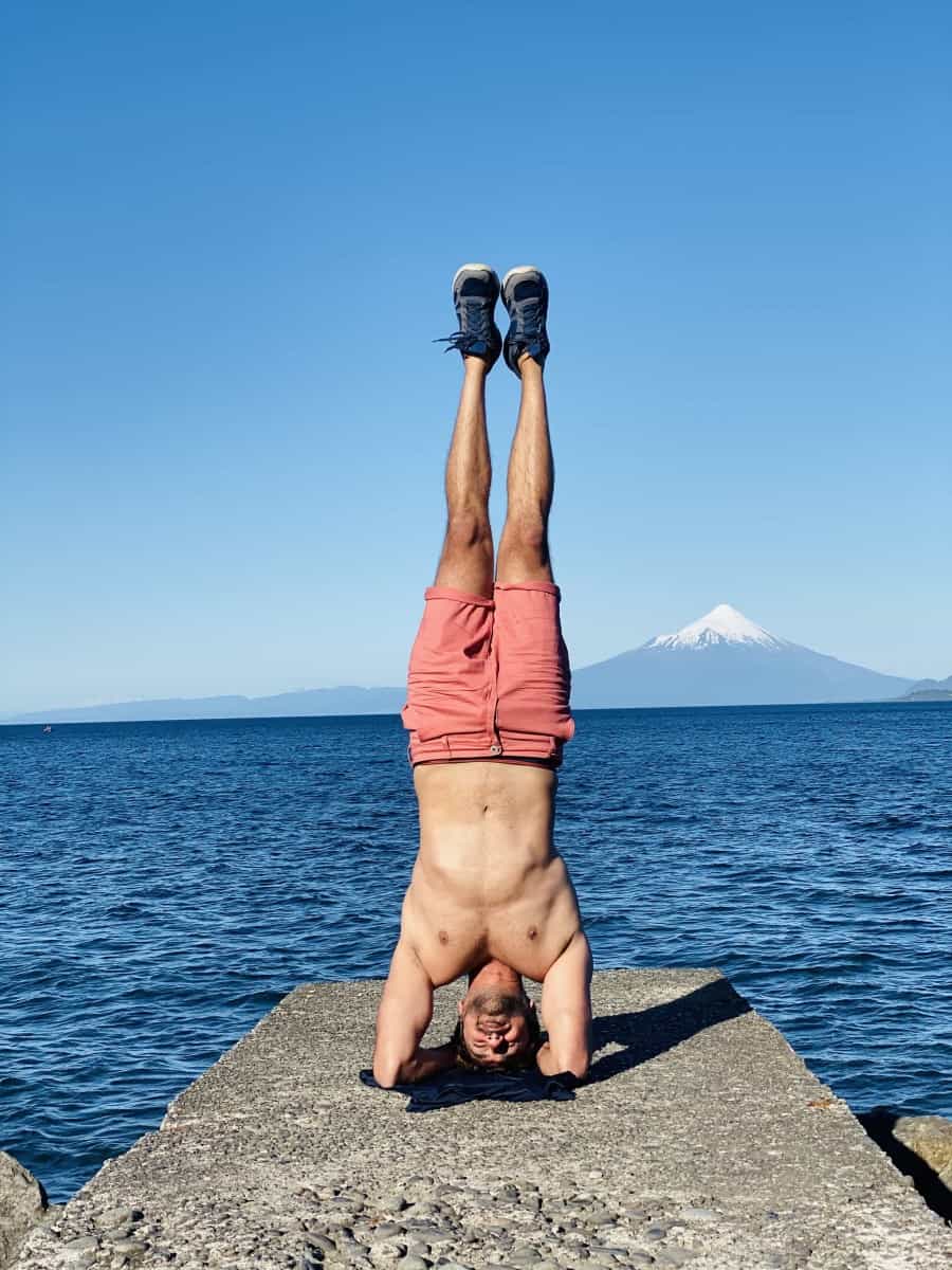Ucman doing a headstand on a pier